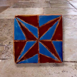 Tile &quot;Corda Seca Brown Star&quot; handmade ceramic tile made of terracotta-colored clay, Corda Seca with engobe white/blue, glazed