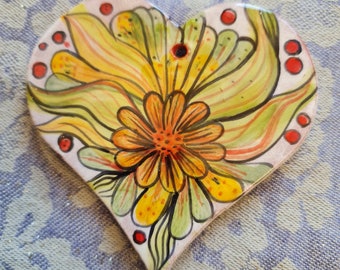 Pendant "Heart Calendula" is handmade and unique. The ceramic is fired from red clay, lovingly hand-painted and glazed.