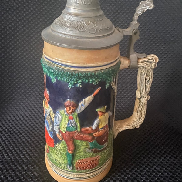 Vintage large German silver lidded beer stein “Tanz Auf der Alm” meaning festive time in the Alps in the spring,repairs cracks see pics