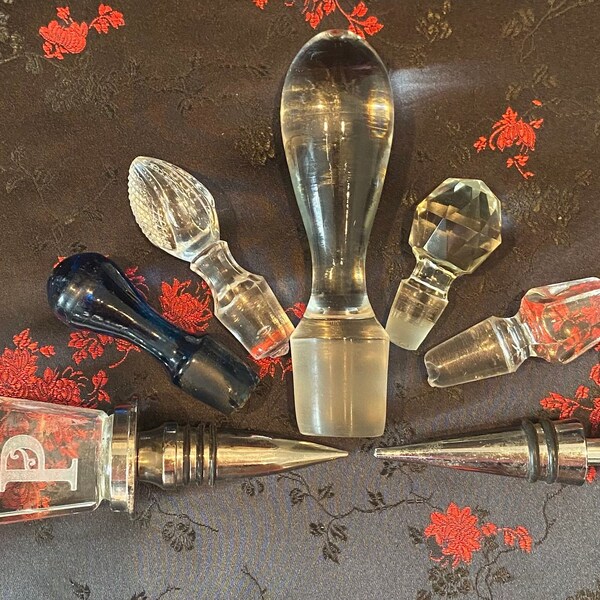 Vintage glass bottle decanter stoppers in several unique shapes and sizes. Solid glass and some with silver. Sold separately