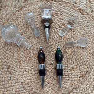 Vintage glass bottle decanter stoppers in several unique shapes and sizes. Some solid, etched, Murano, silver. Sold separately. See pics