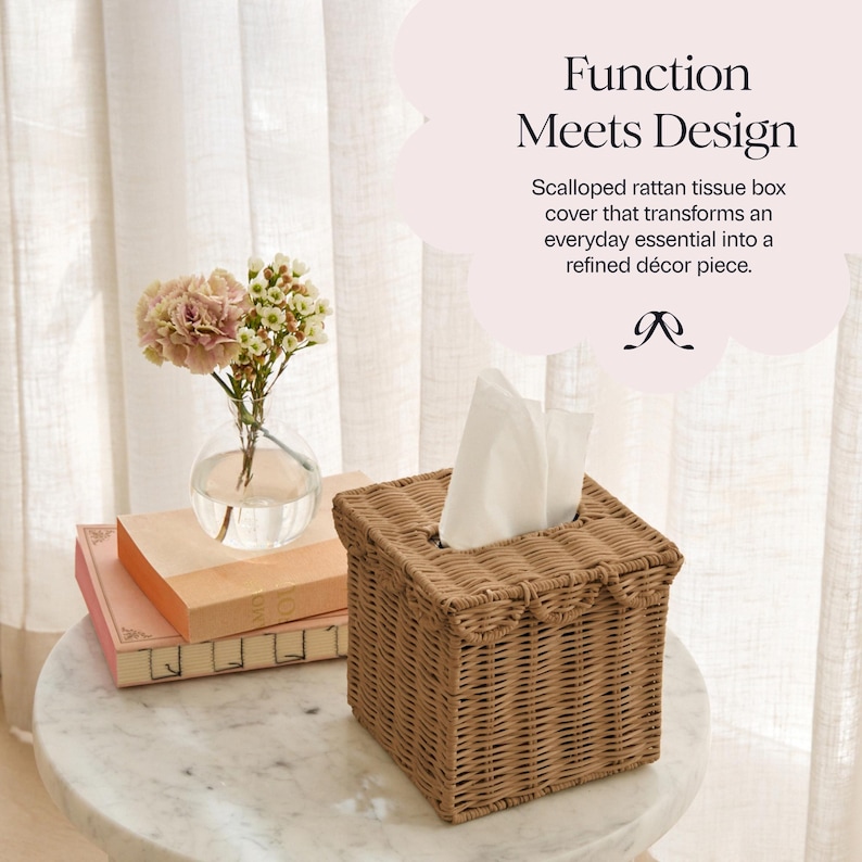 May include: A square, woven rattan tissue box cover in a light brown hue. The cover has a scalloped edge and holds white tissues. The text "Function Meets Design" is visible in the background.