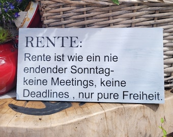 May include: A white wooden sign with black text that reads "RENTE: Rente ist wie ein nie endender Sonntag- keine Meetings, keine Deadlines, nur pure Freiheit."