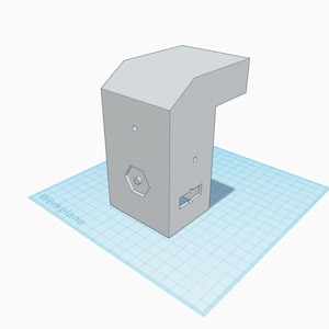 May include: A gray 3D printed box with a hexagonal hole and a rectangular cutout. The box has a small lip on the top.