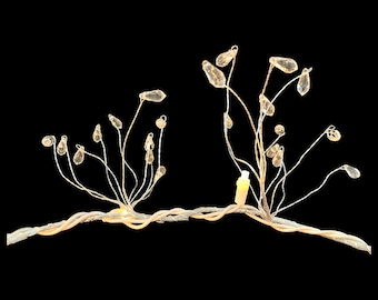 May include: A decorative wire sculpture with crystal accents. The sculpture features two branches with multiple crystal drops hanging from them. The branches are connected by a wire base.