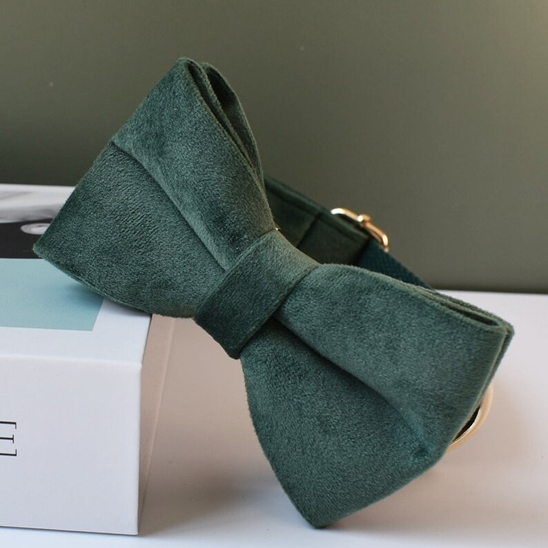 May include: A dark green velvet bow tie. The bow tie is tied and ready to wear.