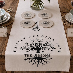 May include: A wooden table set for a family reunion, with a white table runner displaying a family tree design and the text "Family Reunion 2024". The table is decorated with pink roses, wine glasses, place settings, and coasters.