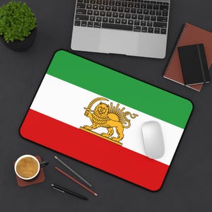 May include: A rectangular mousepad featuring the Iranian flag design. The flag has horizontal stripes of red, white, and green, with the emblem of a golden lion and sun in the center. A white computer mouse rests on the pad.