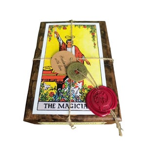 May include: A wooden box with a tarot card illustration of "The Magician" tied with twine. The box is sealed with a red wax stamp and includes a tag that says "Handmade with love". A Chinese coin is also attached.
