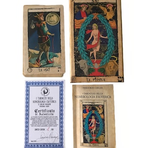 May include: A set of tarot cards with a certificate of authenticity. The cards feature colorful illustrations and are printed on a parchment-like paper. The certificate is blue and white with a gold border. The text on the certificate reads "I Tarocchi della Numerologia Esoterica" and "Certificato di Autenticita".