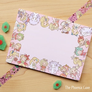 May include: Pink notepad with a border of cartoon characters. The characters are all female and have different colored hair and outfits. The notepad has a white background and the characters are in a circle around the edge.