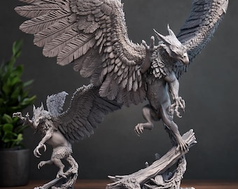 May include: Two detailed gray sculptures of griffins. One griffin is mid-flight, perched on a log, with outstretched wings. The other griffin is smaller, also with outstretched wings. The sculptures are on a wooden surface.