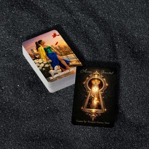 May include: A deck of tarot cards with a woman in a blue dress on the front card. The card next to the deck says "Access Granted" with a keyhole design. The cards are on a dark, textured surface.
