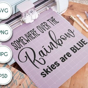 May include: A purple cutting mat with the text "Somewhere over the rainbow skies are blue" in black lettering. The mat is being used with a cutting machine.
