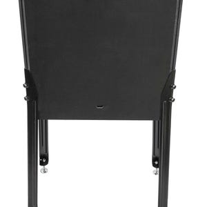 May include: Black metal stand with a rectangular top and four legs. The stand is made of metal and has a black finish.