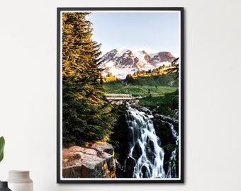 May include: A framed photograph of a waterfall cascading down a rocky cliff in a lush green forest. A snow-capped mountain peak is visible in the background.
