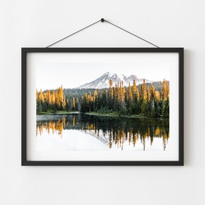 Mountain reflecting in lake with trees in mt rainier national park wall photo framed hanging on a wall.