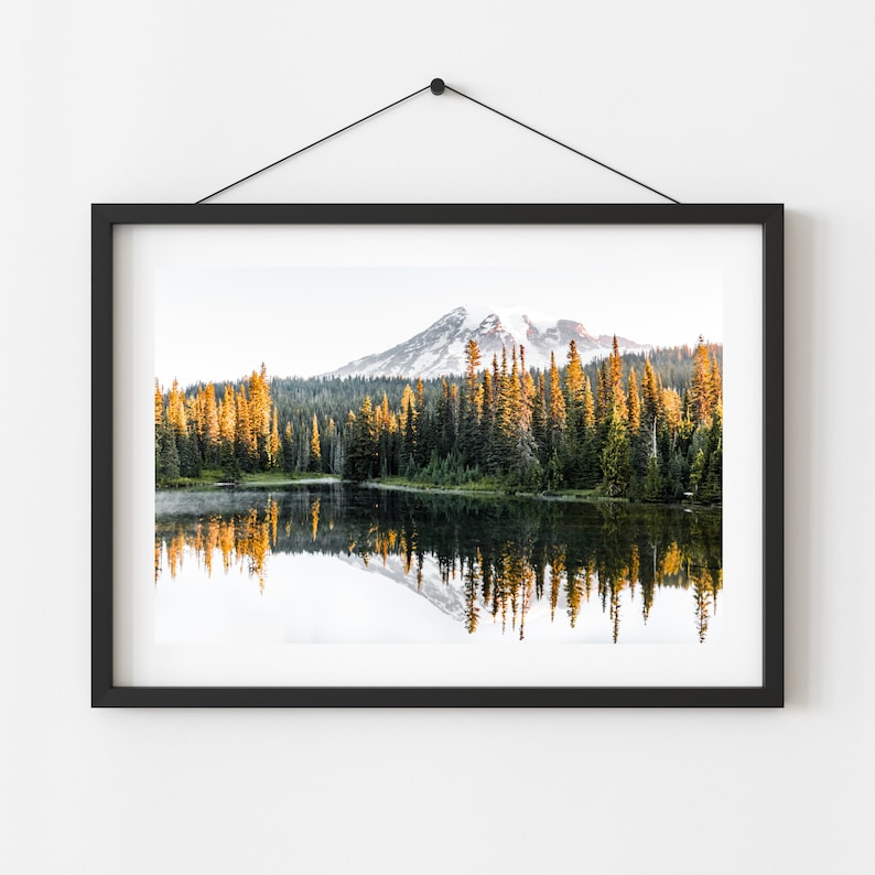Mountain reflecting in lake with trees in mt rainier national park wall photo framed hanging on a wall.