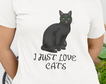 May include: White t-shirt with a black cat illustration and the text "I just love cats".