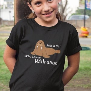 May include: A black t-shirt with a cartoon walrus and the text "Just A Girl Who Loves Walruses".