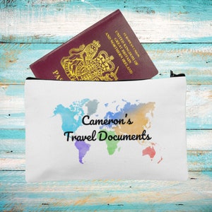 May include: White travel pouch with a watercolor world map design and the text "Cameron's Travel Documents".