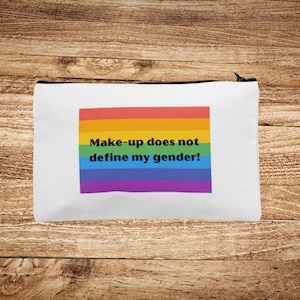 May include: White zippered pouch with a rainbow stripe design and the text "Make-up does not define my gender!"