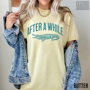 Funny 'After a While, Crocodile' t-shirt with playful crocodile graphic, perfect for fans of humorous, sarcastic, and novelty tees. Great gift for Mother's Day or anyone who loves witty sayings, Comfort Colors Butter Shirt