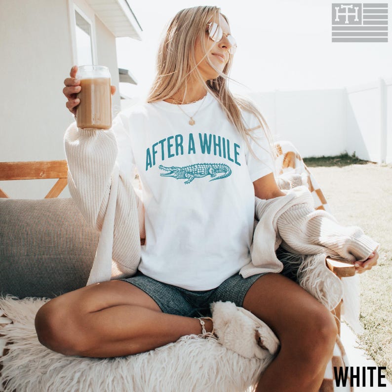 Funny 'After a While, Crocodile' t-shirt with playful crocodile graphic, perfect for fans of humorous, sarcastic, and novelty tees. Great gift for Mother's Day or anyone who loves witty sayings, Comfort Colors White Shirt