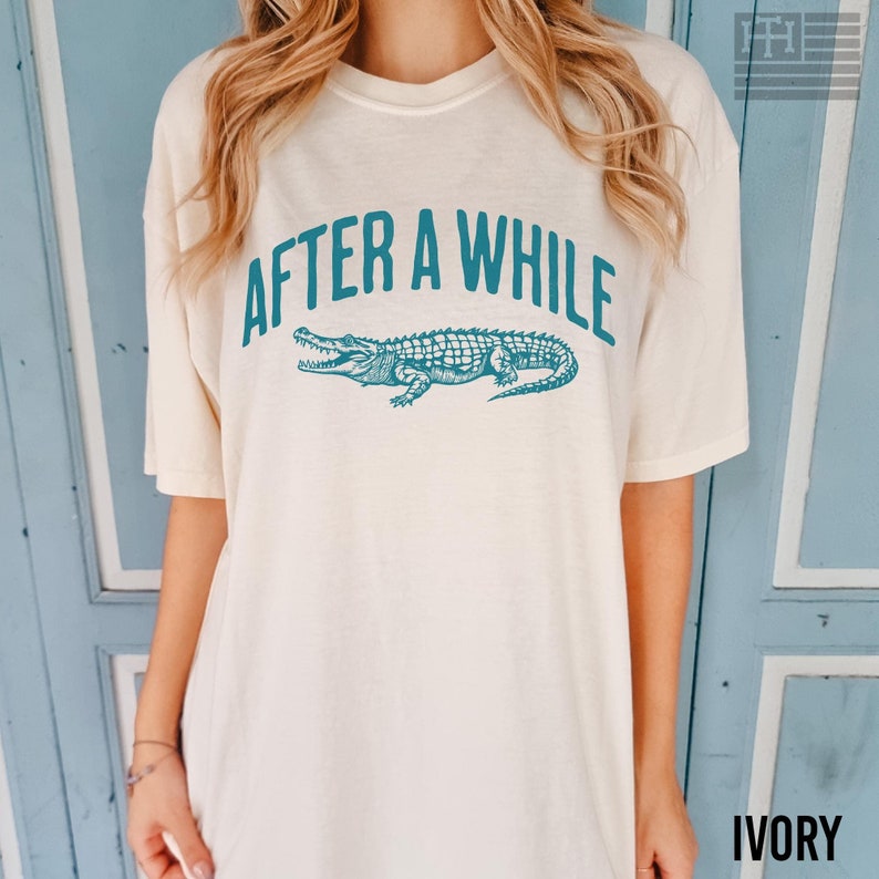 Funny 'After a While, Crocodile' t-shirt with playful crocodile graphic, perfect for fans of humorous, sarcastic, and novelty tees. Great gift for Mother's Day or anyone who loves witty sayings, Comfort Colors Ivory shirt