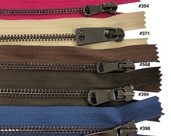 May include: Five different colors of zipper tape with black metal zipper pulls. The colors are pink, beige, brown, olive green, and blue. The zipper pulls are labeled with numbers: #354, #371, #568, #394, and #398.