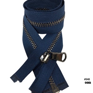 May include: A close-up of a dark blue zipper with a silver metal slider and pull. The zipper is folded in half and the slider is in the middle of the zipper. The zipper is labeled #040 and 6.5" (16.5 cm).