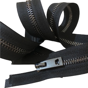 May include: Black zipper tape with a silver metal zipper pull and teeth. The zipper tape is folded and twisted, showing the details of the zipper.