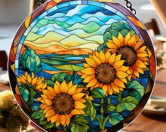 May include: A round stained glass panel featuring a vibrant sunflower design. The artwork showcases a landscape with sunflowers, blue skies, and rolling hills. The panel is held by a black chain.
