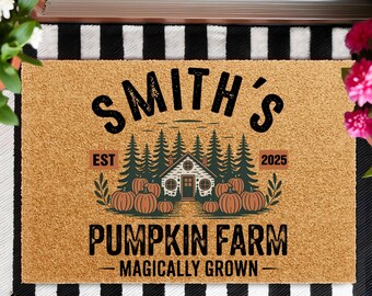 May include: A rectangular doormat with a tan background and black and white striped border. The mat features the text "SMITH'S PUMPKIN FARM" with a graphic of a house, pumpkins, and trees. The text "EST 2025" is also included.