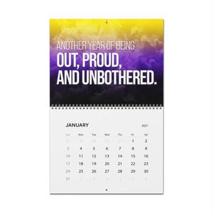 May include: A wall calendar for January 2027 featuring a top section with a yellow to purple smoke gradient background and the white text: ANOTHER YEAR OF BEING OUT, PROUD, AND UNBOTHERED. The bottom section displays a standard monthly grid.