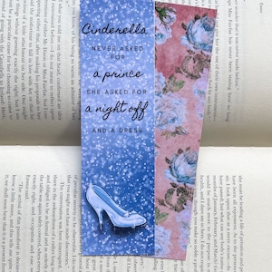 May include: A blue and white bookmark featuring a glass slipper illustration and the text "Cinderella never asked for a prince, she asked for a night off and a dress".