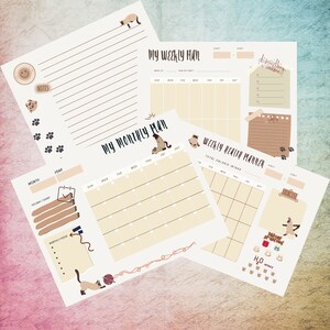 May include: A set of printable cat-themed planner pages. The pages include a weekly planner, a monthly planner, and a weekly health planner. The pages are decorated with cute cat illustrations and paw prints.