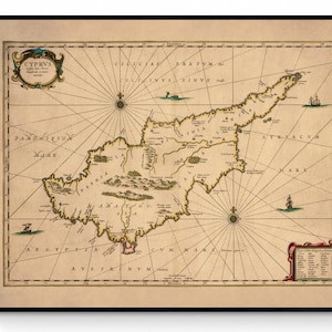 May include: Framed vintage map of Cyprus, with detailed illustrations and nautical features. The map is in beige, brown, and green, with the word "CYPRVS" in a decorative cartouche. The map is framed in a black frame.
