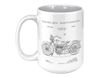 May include: White ceramic mug with a black and white illustration of a Harley Davidson motorcycle and the text "Harley Davidson" with patent information. The text reads "July 2, 1924", "W. S. Harley et al.", "Filed June 6, 1923", "1,478,551".
