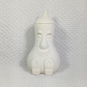 May include: White ceramic gourd-shaped jar with a lid and a cartoon face. The jar has a wide base and a narrow neck. The face has closed eyes, a large nose, and a smiling mouth. The jar is sitting on a white surface.