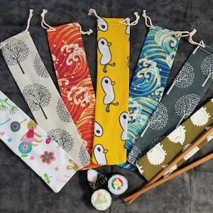 May include: A set of eight fabric pouches with various patterns, including trees, waves, and birds. The pouches are made of a natural fabric and have a drawstring closure. The pouches are perfect for storing chopsticks, straws, or other small items.