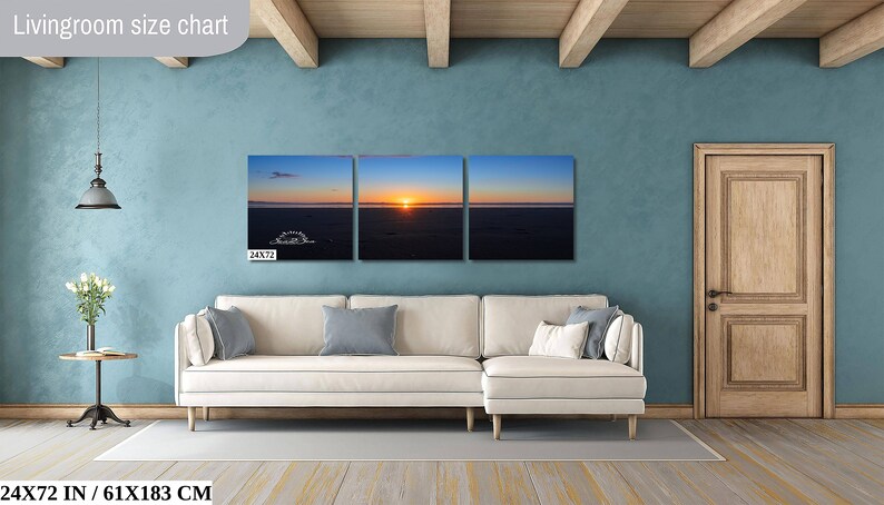 Waves form a curtain from horizon to horizon as the sunset creates a spectacular, colorful display of oranges, and yellows as it sets over Playa Tamarindo, Costa Rica. A 24x72 inch print hangs above a sectional sofa for perspective.