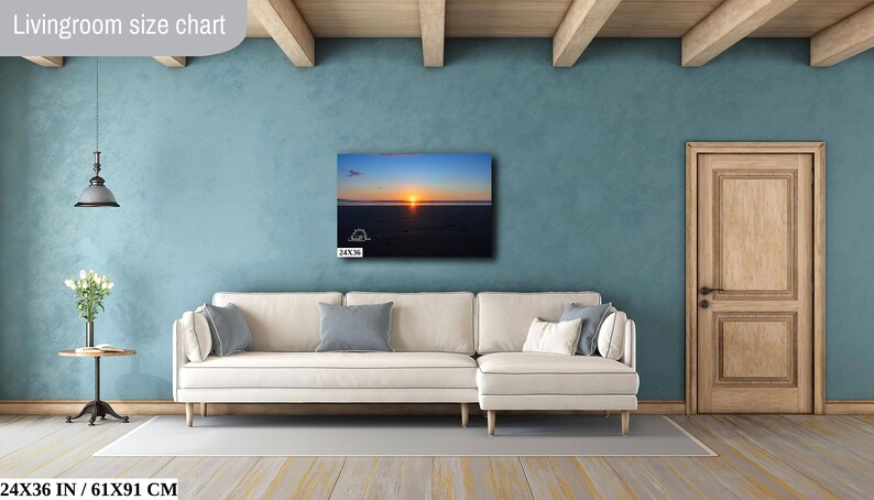 Waves form a curtain from horizon to horizon as the sunset creates a spectacular, colorful display of oranges, and yellows as it sets over Playa Tamarindo, Costa Rica. A 24x36 inch print hangs above a sectional sofa for perspective.
