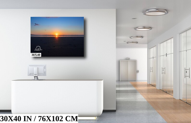 Waves form a curtain from horizon to horizon as the sunset creates a spectacular, colorful display of oranges, and yellows as it sets over Playa Tamarindo, Costa Rica. A 30x40 inch print hangs above an office reception desk for perspective.