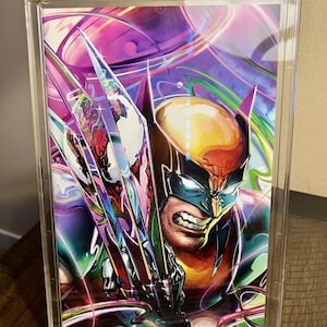 May include: A colorful comic book featuring Wolverine with his claws extended, framed in a clear acrylic display case with a black base that reads "Gator Guard".