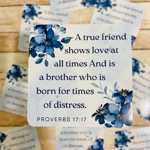 May include: A blue and white floral design card with the quote "A true friend shows love at all times And is a brother who is born for times of distress."  The quote is from Proverbs 17:17.