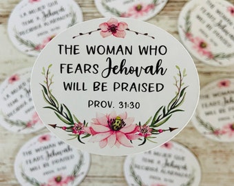 May include: White round stickers with the text "THE WOMAN WHO FEARS Jehovah WILL BE PRAISED" in black script, surrounded by a floral wreath. Additional stickers with similar designs are scattered around.