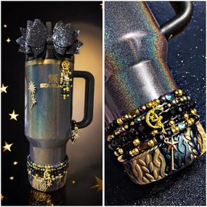 May include: A glittery, iridescent tumbler with a black handle and bow. The tumbler is adorned with beaded bracelets, charms, and a starburst design. The Stanley logo is visible on the side.