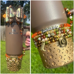 May include: A brown insulated tumbler with a decorative bow, beaded accents, and a gold-colored base. The base features a cut-out design and charms, including a cowboy hat and boot. The text "Add name here" is visible.