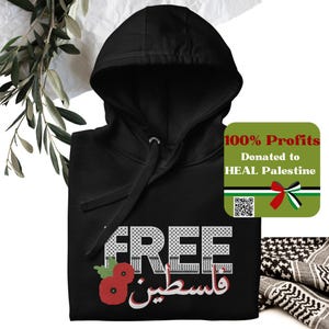May include: Black hoodie with the words "FREE فلسطين" in white and red, with a poppy flower graphic. The text "100% Profits Donated to HEAL Palestine" is on a green label with a QR code and a red ribbon.
